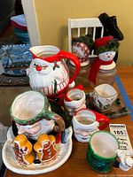 Group shot of entire collection showing pitcher, mugs, jars, platter, shakers