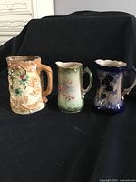 Overview of the three ceramic pitchers together