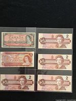 Obverse view of all six notes in plastic sleeve