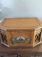 Front view of Emerson wooden stereo system showing cabinet and speakers