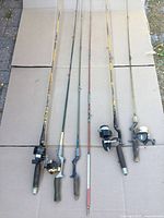 Six rods laid out, showing overall length and attached reels