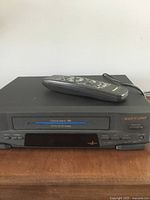 Front view of Panasonic PV-4551-K VCR with remote resting on top