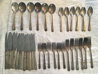 All pieces laid out showing spoons, knives, forks