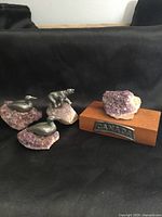 Lot overview showing three pewter animal figurines on amethyst bases and separate amethyst on wood base