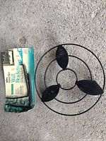 Plant caddy and packaged wall brackets laid out on floor