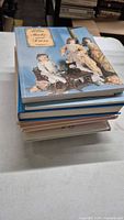 Stack of eight hardcover doll collecting books