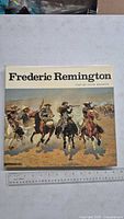 Front cover of hardcover art book with Frederic Remington title and rider illustration