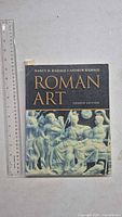 Front cover of Roman Art book with ruler for scale