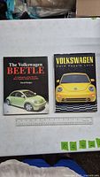 Both Volkswagen hardcover books with ruler for scale