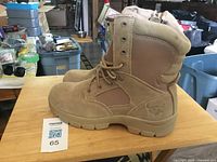 Side view of both tan Texas Steer boots on table