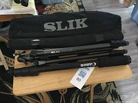 Slik Sprint Pro GM tripod, Canon monopod and Slik bag on table