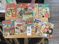 Top view showing all nine comics on table