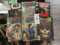 Front view of six comic books arranged on table
