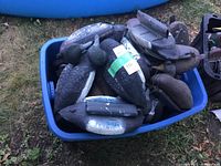 Bin full of assorted weighted plastic duck decoys