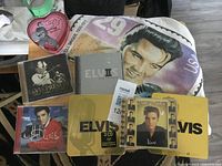 All items overview including T-shirt, CDs, tins