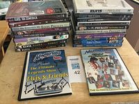Overall lot showing 21 Elvis DVDs, two signed tribute DVDs