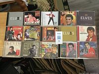 Overview of 15 Elvis Presley CDs laid out in three rows