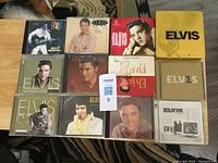 All 12 Elvis Presley CDs laid out in 3 rows of 4