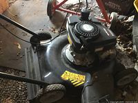 Top view of Yardworks 140cc gas mower showing engine, deck, wheels