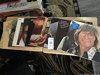 Ten John Denver LPs spread on table showing front covers