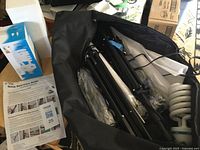 Bag open showing stands, umbrellas, bulb, manual