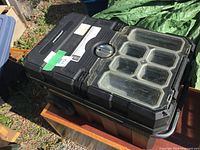 Closed rolling tool box showing lid organizers and handle