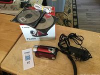 Camcorder, box, CDs, cable, power adapter visible