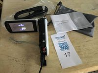 Camcorder powered on with accessories visible