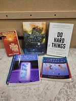 Group shot of all five books front covers visible