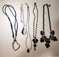 All five necklaces laid out side by side