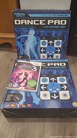 Front view of both boxed dance pads and Wii game case