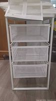 Front view of 3-drawer metal unit with shoe storage pieces stacked on top