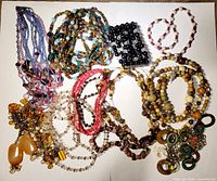 Group shot of all beaded jewelry pieces spread on white background