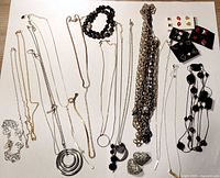 Full lot showing necklaces, bracelet and earring cards laid out