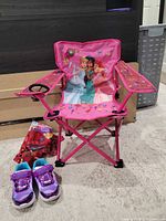 Full lot view showing Disney Princess chair open, carry bag and Skechers shoes