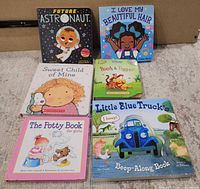 Six board books arranged on floor showing covers