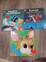 Front covers of all three Christmas books