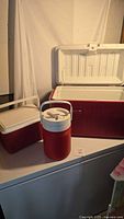Overview of three coolers: large chest, small lunch, water jug