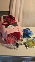 Overall lot showing carrier, harness, toys, catnip, wires