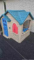 Full view of Little Tikes playhouse front and side on deck