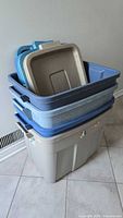 Stacked view of four Rubbermaid totes showing colours and lids