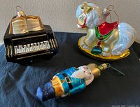 Front view of piano, pony and nutcracker ornaments