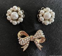 Front view of bow brooch and both pearl cluster earrings
