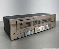 Angled front view of the Marantz SD 142 stereo cassette deck showing the cassette compartment, control buttons, and meters.