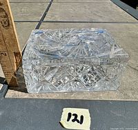 Rectangular clear cut crystal trinket box with lid, marked 121, shown against a ruler for size reference.