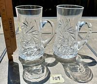 Pair of clear crystal mini tankard mugs next to a ruler showing height approx. 3.75 inches