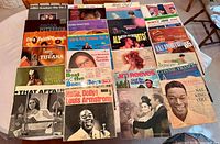 Photo showing 25 vintage LP albums, highlighting titles like ABBA Greatest Hits Vol. 2, Elvis' Golden Records, Best of the Beach Boys Vol. 2, Louis Armstrong's Hello Dolly, Jim Reeves, Nana Mouskouri, Nat King Cole – In Person, and Frank Sinatra. Also includes niche albums 'A Taste of Tijuana,' 'Mitch Ryder Hits!, 'That Affair' with abstract art, and a few foreign pressings.