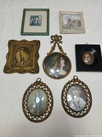 Overview of all seven framed art pieces on white background