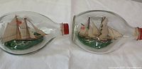 Two ship-in-bottle models side by side showing full detail and condition