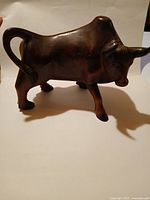 Side view of entire hardwood bull sculpture